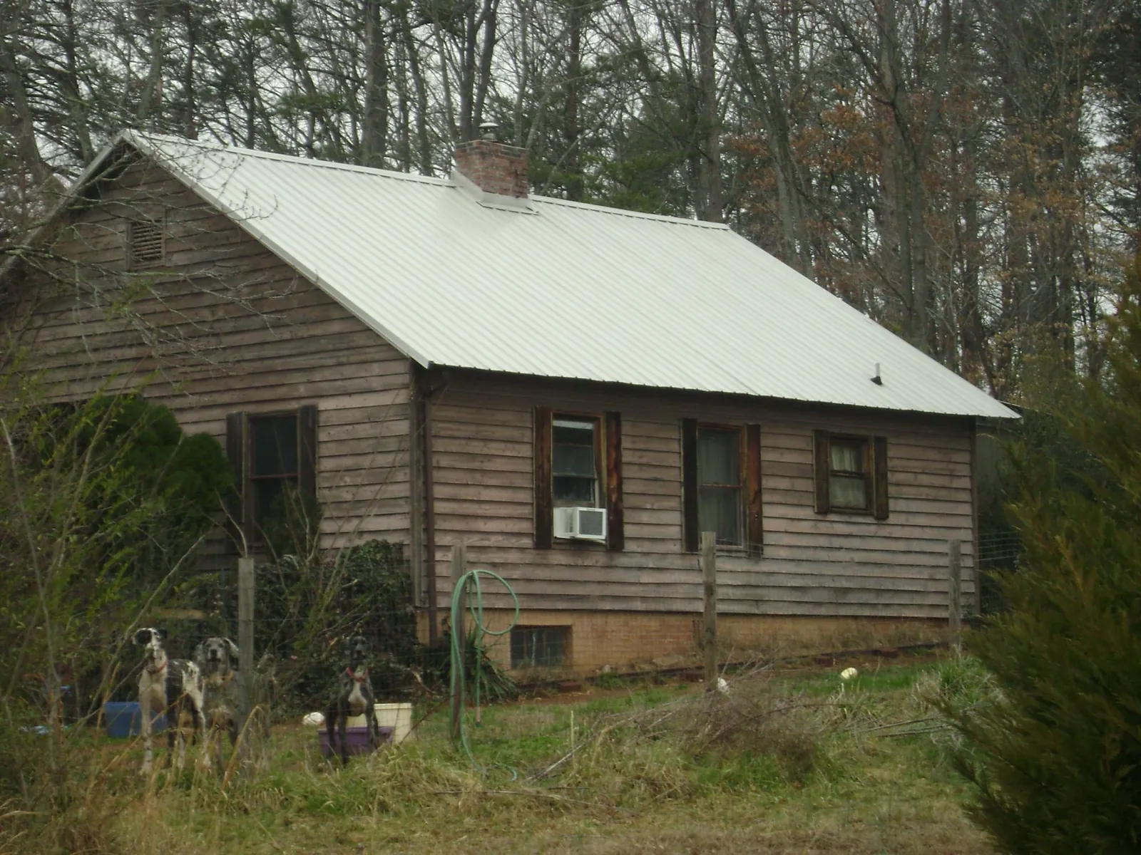 White metal roof on an old wood sided farmhouse, from a Metal Roof Installation job in Rye